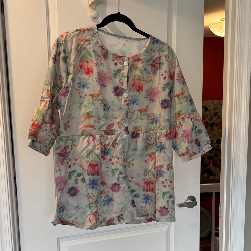 Beautifully patterned bottom down smocked blouse.  Brand new with no tags.